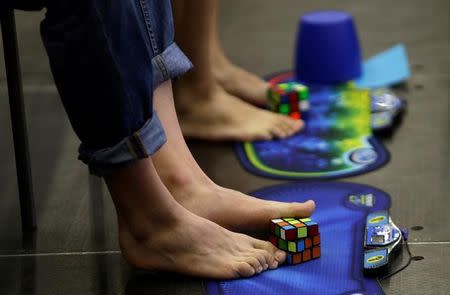 Competitors solve Rubik's cubes using their feet during the Rubik's Cube European Championship in Prague, Czech Republic, July 15, 2016. Picture taken July 15, 2016. REUTERS/David W Cerny