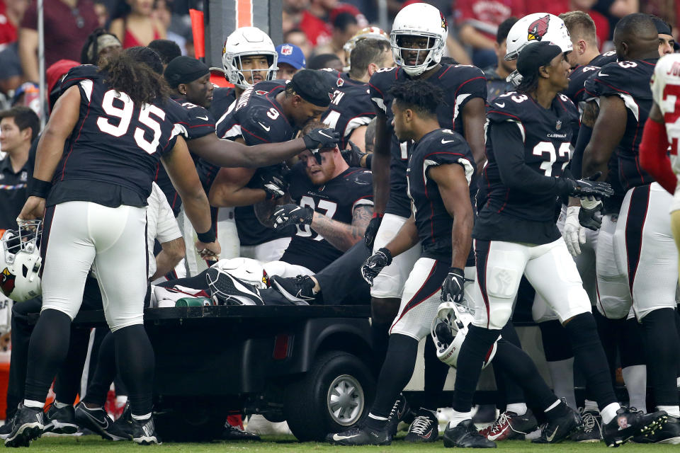 Teammates speak with Arizona Cardinals tight end Maxx Williams (87) as he leaves the game with an injury during the first half of an NFL football game against the San Francisco 49ers, Sunday, Oct. 10, 2021, in Glendale, Ariz. (AP Photo/Ralph Freso)