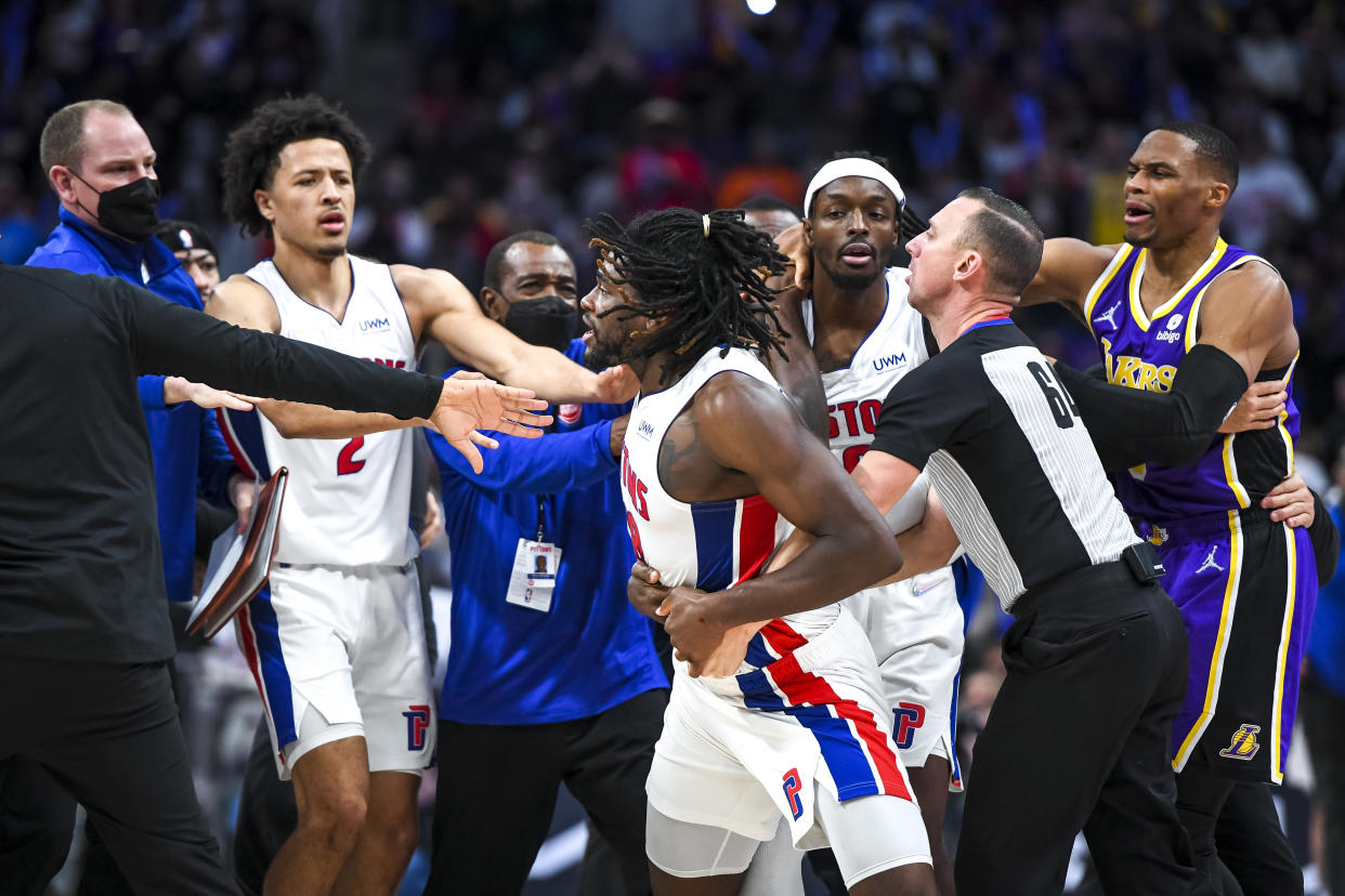 Isaiah Stewart is restrained as he goes after LeBron James after James hit Stewart with an elbow, drawing blood.