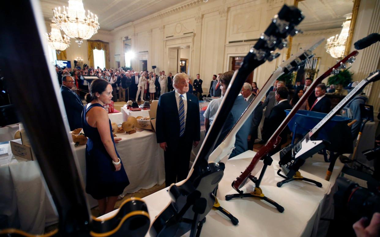 Donald Trump inspects Gibson guitars during a