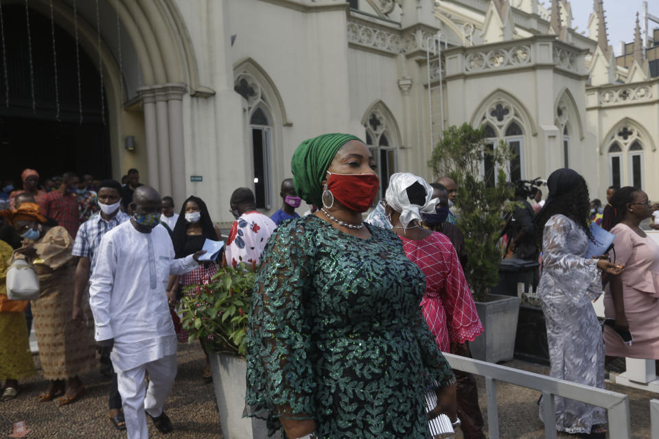 Parishioners wearing face masks to protect against coronavirus, exits after a morning Christmas Mass at Holy Cross Cathedral in Lagos, Nigeria, Friday Dec. 25, 2020. Africa's top public health official says another new variant of the coronavirus appears to have emerged in Nigeria, but further investigation is needed. The discovery could add to new alarm in the pandemic after similar variants were announced in recent days in Britain and South Africa and sparked the swift return of travel restrictions. (AP Photo/Sunday Alamba)