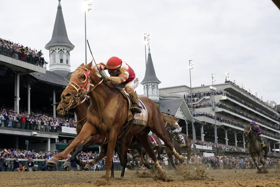 FILE - Rich Strike, with Sonny Leon aboard, crosses the finish line to win the 148th running of the Kentucky Derby horse race at Churchill Downs Saturday, May 7, 2022, in Louisville, Ky. Rich Strike, upset winner of the 2022 Kentucky Derby, has been retired after injuries kept him from returning to racing. The 4-year-old colt will be sold as a stallion prospect. (AP Photo/Jeff Roberson, File)