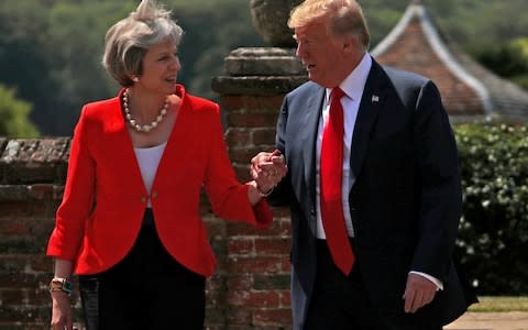 Theresa May and U.S. President Donald Trump walk to a joint news conference at Chequers, the official country residence of the Prime Minister, near Aylesbury, last year - Credit: Hannah McKay/Reuters