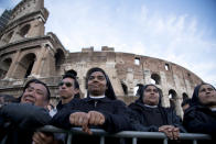 Nuns and faithful wait for the start of the Via Crucis (Way of the Cross) torchlight procession to be celebrated by Pope Francis in front of the Colosseum on Good Friday in Rome, Friday, April 18, 2014. (AP Photo/Gregorio Borgia)