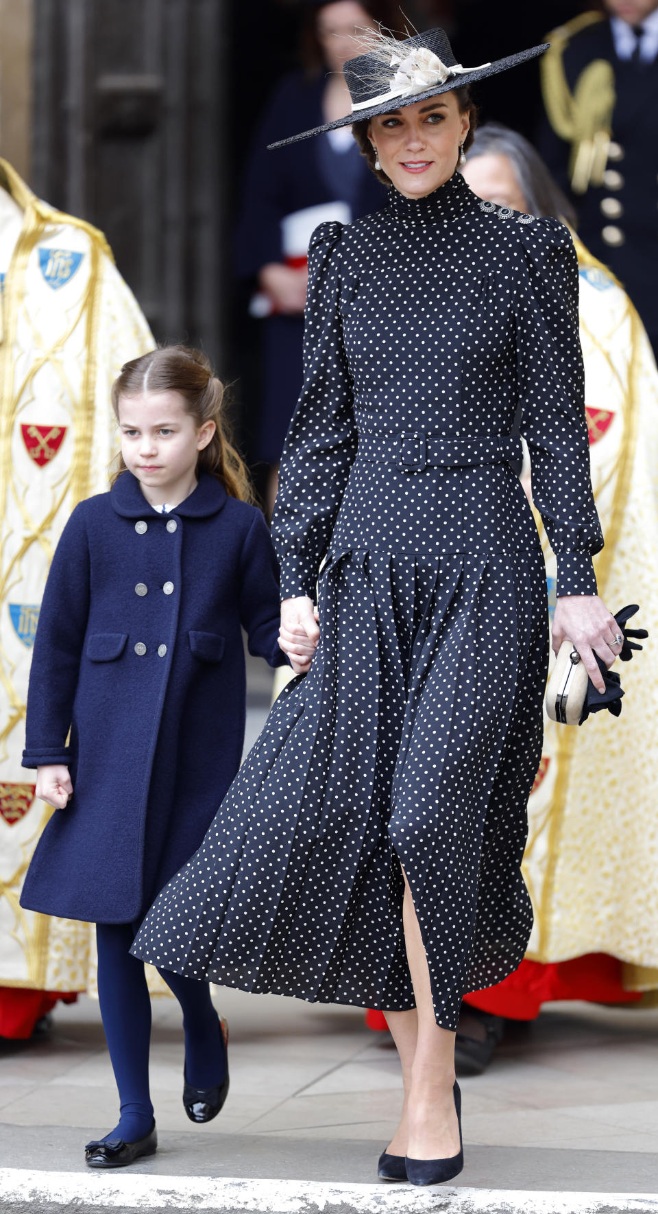 Princess Charlotte held onto her mother's hand as she arrived at the Abbey. (Getty Images)