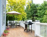 <p> For raised decks, decking railings are a must. But as well as being necessary for safety reasons, they can also boost the aesthetic appeal of your BBQ space. </p> <p> This bright white border is a perfect example as it provides a smart backdrop to the sleek grill and covered dining area. Don&apos;t forget about adding some container gardening to the scene too, for that extra pop of color and interest. </p>