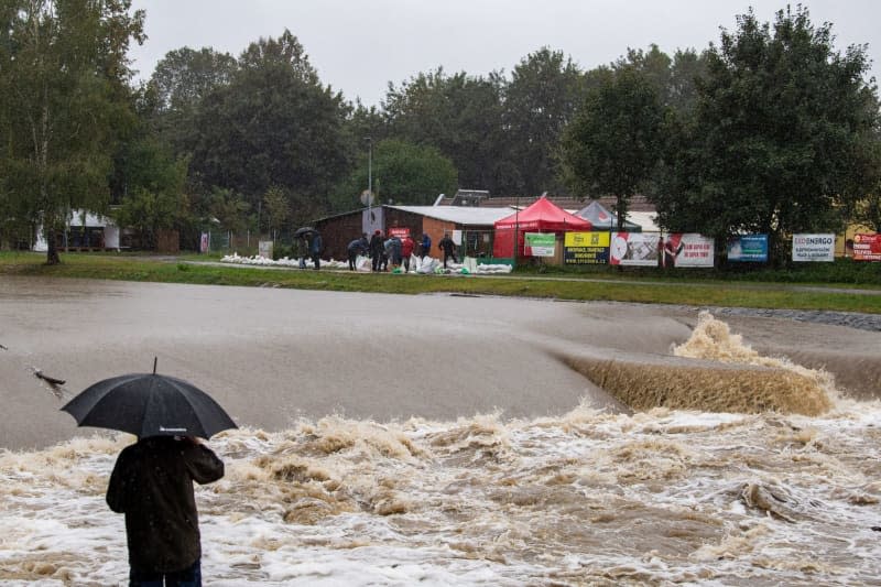 A person with an umbrella looks at the Male River. Heavy persistent rainfall has led to flood warnings on many rivers and streams in the Czech Republic. Pancer Václav/CTK/dpa