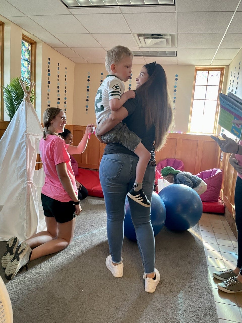 Paige Petek of Des Moines holds her son Keaton Petek, 6, in the calming room at the Iowa State Fair on Aug. 17.