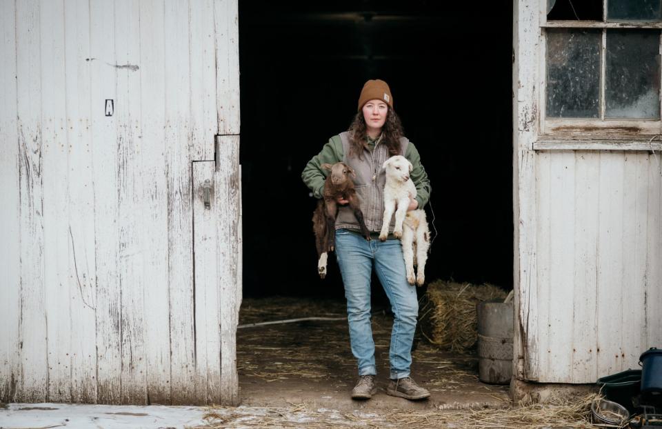 Rachel Wagoner holds newly born lambs on Jan. 18, 2024, at her family's farm in Darlington, Pa. The fourth-generation farm is located about 3 miles from the site of the Feb. 3, 2023, Norfolk Southern train derailment.