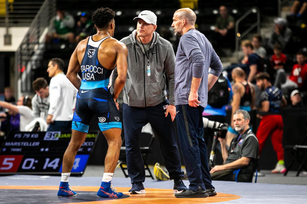 Cael Sanderson, center, coaches Carter Starocci during the 2022 USA Wrestling World Team Trials tournament in Iowa. Starocci is now a three-time NCAA champ -- and one of the main reasons why this Penn State team could be its most dynamic ever.
