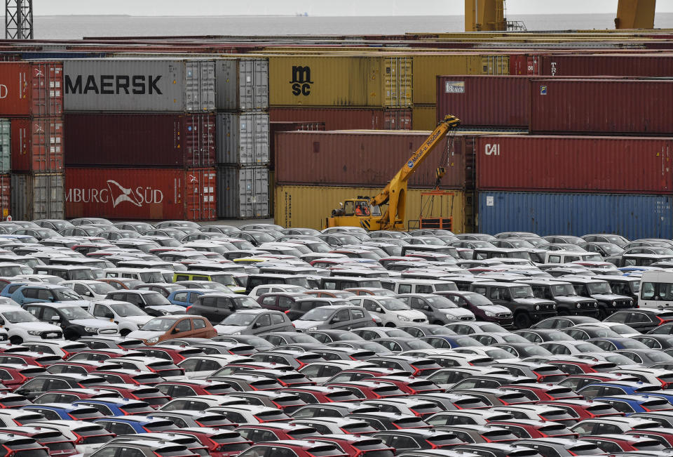 File - In this Thursday, May 16, 2019, file photo, cars for export and import are stored in front of containers at the port in Bremerhaven, Germany. The German economy returned to modest growth in the July-September 2019 period, averting a widely-feared recession. The Federal Statistical Office said Thursday gross domestic product grew 0.1% compared with the previous quarter. (AP Photo/Martin Meissner)