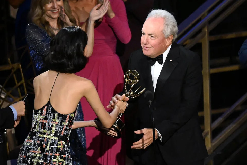 Canadian-US producer and creator of "Saturday Night Live" Lorne Michaels (R) accepts the award for Outstanding Variety Sketch Series from South Korean actress Jung Ho-yeon onstage during the 74th Emmy Awards at the Microsoft Theater in Los Angeles, California, on September 12, 2022.