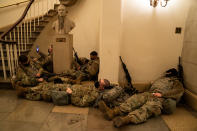 WASHINGTON, DC - JANUARY 13: Members of the National Guard sleep in the halls of Capitol Hill as the House of Representativs convene to impeach President Donald Trump, nearly a week after a pro-Trump insurrectionist mob breached the security of the nations capitol while Congress voted to certify the 2020 Election Results on Wednesday, Jan. 13, 2021 in Washington, DC. (Kent Nishimura / Los Angeles Times via Getty Images)