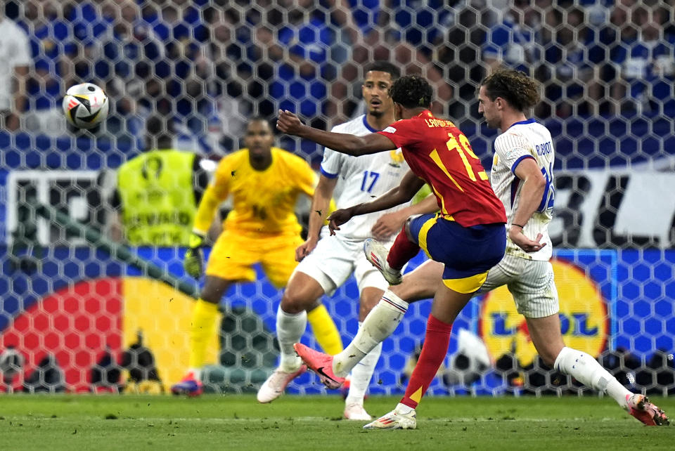 Spain's Lamine Yamal, center, scores his side's first goal during a semifinal match between Spain and France at the Euro 2024 soccer tournament in Munich, Germany, Tuesday, July 9, 2024. (AP Photo/Matthias Schrader)