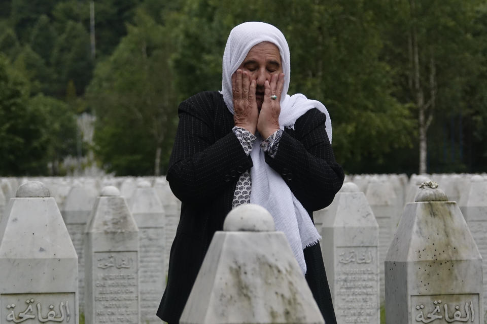 Munira Subasic who lost her son and the husband in Srebrenica massacre prays at the memorial cemetery in Potocari near Srebrenica, Bosnia, Friday, May 28, 2021. U.N. judges on Tuesday, June 8 deliver their final ruling on the conviction of former Bosnian Serb army chief Radko Mladic on charges of genocide, war crimes and crimes against humanity during Bosnia’s 1992-95 ethnic carnage. Nearly three decades after the end of Europe’s worst conflict since World War II that killed more than 100,000 people, a U.N. court is set to close the case of the Bosnian War’s most notorious figure. (AP Photo/Eldar Emric)