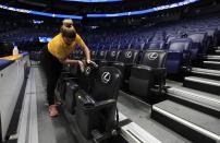 A worker cleans the seats after the announcement of the cancellation of the SEC Basketball Tournament at Bridgestone Arena on March 12, 2020 in Nashville, Tennessee. The tournament has been cancelled due to the growing concern about the spread of the Coronavirus (COVID-19). The NCAA tournament has also been cancelled. (Photo by Andy Lyons/Getty Images)