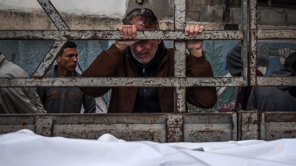 PHOTO: A man mourns as the shrouded bodies of loved ones killed during Israeli bombardment arrive at Al-Najar hospital in Rafah on the southern Gaza Strip, Dec. 29, 2023. (AFP via Getty Images)