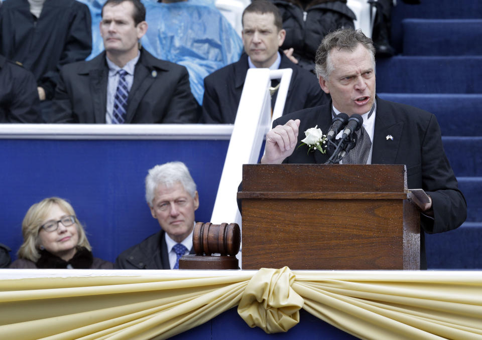 Virginia Gov. Terry McAuliffe, right, delivers his inaugural address as former U.S. Secretary of State Hillary Rodham Clinton, left, and former U.S. President Bill Clinton look on during inaugural ceremonies at the Capitol in Richmond, Va., Saturday, Jan. 11, 2014. McAuliffe is the 72nd governor of Virginia. (AP Photo/Patrick Semansky)