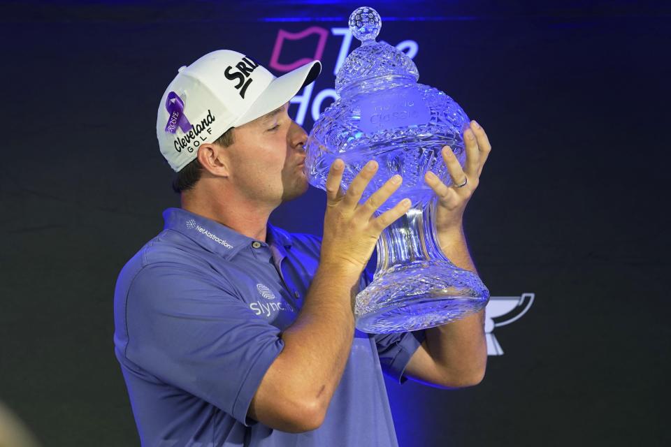 Sepp Straka, of Austria, kisses the Honda Classic trophy after winning during the final round of the golf tournament, Sunday, Feb. 27, 2022, in Palm Beach Gardens, Fla. (AP Photo/Marta Lavandier)