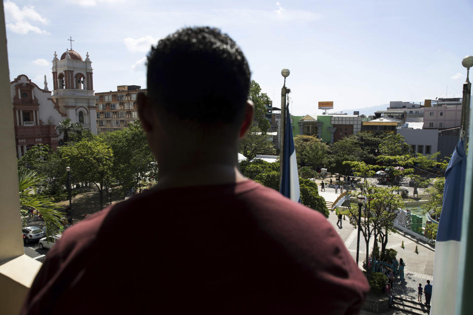 A Honduran man deported from the United States looks over the central park of San Pedro Sula, Honduras on Dec. 1, 2019. As he was walking in the area in November, a man stepped toward him, fired one shot from a pistol, and fled. He says he and his relatives have been hunted for more than 20 years by a powerful criminal family from his small hometown. "I've spent my whole life running. … One day they are going to get me." (AP Photo/Moises Castillo)