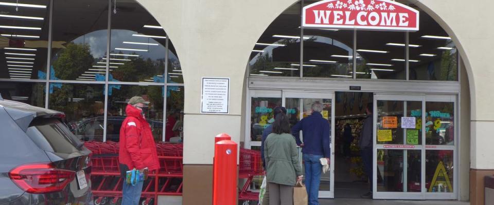 Lineup of people waiting to go into Trader Joe's grocery store