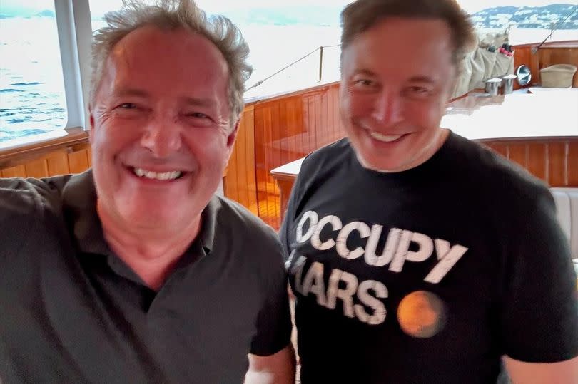 Piers Morgan and Elon Musk in a selfie together on a boat.