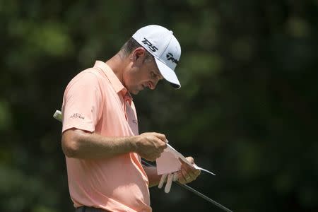 May 26, 2018; Fort Worth, TX, USA; Justin Rose checks his scorecard on the fifth green during the third round of the Fort Worth Invitational golf tournament at Colonial Country Club. Mandatory Credit: Jerome Miron-USA TODAY Sports