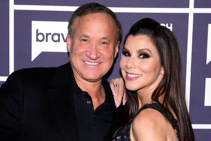 Heather and Terry smiling together in front of a step and repeat.