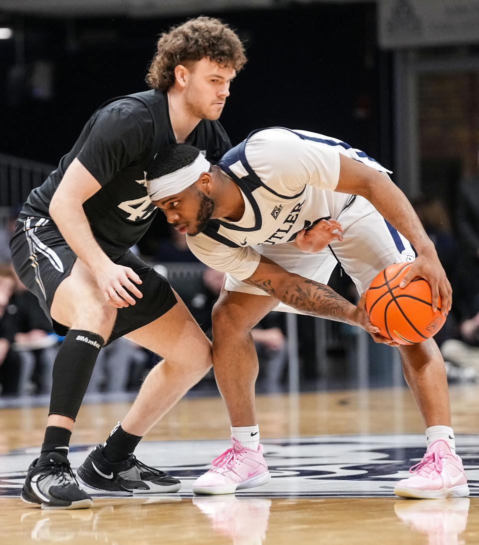 Butler Bulldogs guard Posh Alexander (5) is guarded by Xavier Musketeers guard Brad Colbert (45) on Wednesday, March 6, 2024, during the game at Hinkle Fieldhouse in Indianapolis. The Butler Bulldogs defeated the Xavier Musketeers, 72-66.