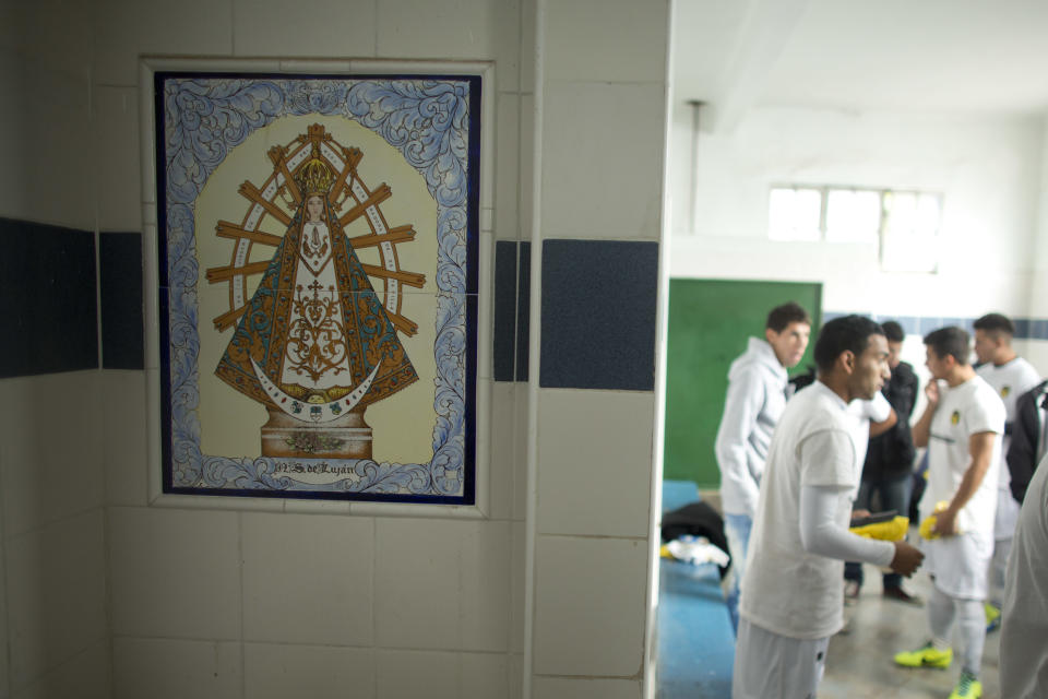 Soccer players from the new team "Papa Francisco," or Pope Francis, get ready for a game in their locker room decorated with an image of Our Lady of Lujan, Argentina's Patron Saint in Lujan, Argentina, Saturday, April 12, 2014. The new semiprofessional team named their team in honor of the pontiff from Argentina. (AP Photo/Victor R. Caivano)