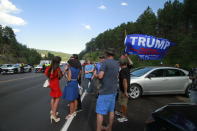 Trump supporters, some who were blocked from reaching Mount Rushmore by a blockade set up by Native American protesters, gather near where protesters clashed with law enforcement officers in Keystone, S.D., Friday, July 3, 2020.. (AP Photo/Stephen Groves)