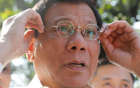 Philippine President Rodrigo Duterte holds his glasses as he speaks to reporters at the presidential palace in Manila, Philippines April 28, 2017. REUTERS/Erik De Castro