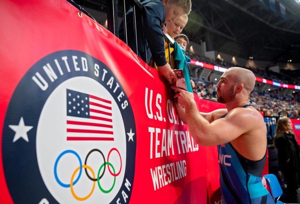 Max Dean signs autographs for a group of fans after his 86 kg win over Connor Mirasola during the U.S. Olympic Team Trials at the Bryce Jordan Center on Friday, April 19, 2024.