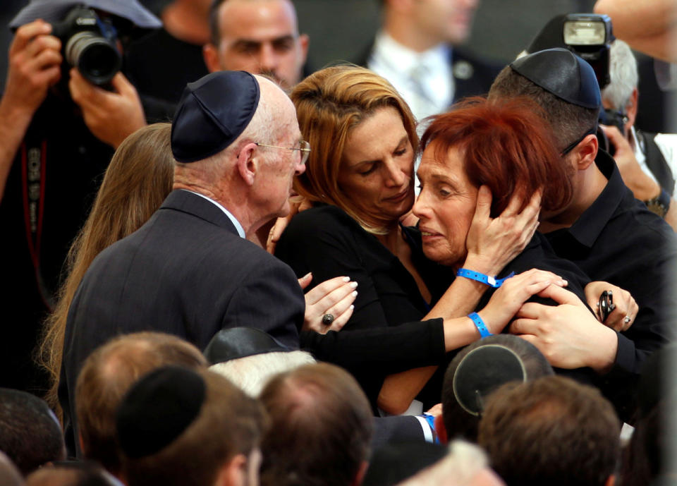 <p>Tsvia, the daughter of former Israeli President Shimon Peres is comforted by her family as she mourns during her father’s funeral ceremony at Mount Herzl cemetery in Jerusalem on Sept. 30, 2016. (REUTERS/Baz Ratner)</p>