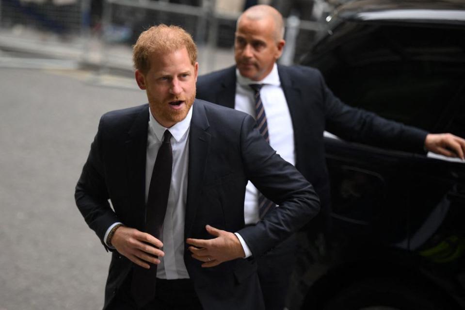 Prince Harry in dark suit walking into court