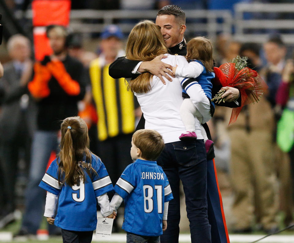 <p>As part of the team’s annual “Salute to Service” game, the Detroit Lions welcomed Michigan native, Marine Captain Josh Munsee and his family for a surprise on-field homecoming between the first and second quarter of the game against the Tampa Bay Buccaneers at Ford Field on November 24, 2013 in Detroit, Michigan. (Photo by Gregory Shamus/Getty Images) </p>