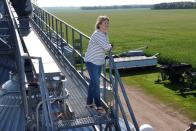 Vanessa Kummer stands on farm catwalk near Colfax, North Dakota