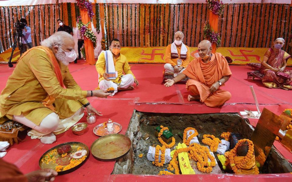Mr Modi, left, worships at Shree Ram Janmabhoomi Mandir in Ayodhya - INDIA PRESS INFORMATION BUREAU HANDOUT/EPA-EFE/Shutterstock