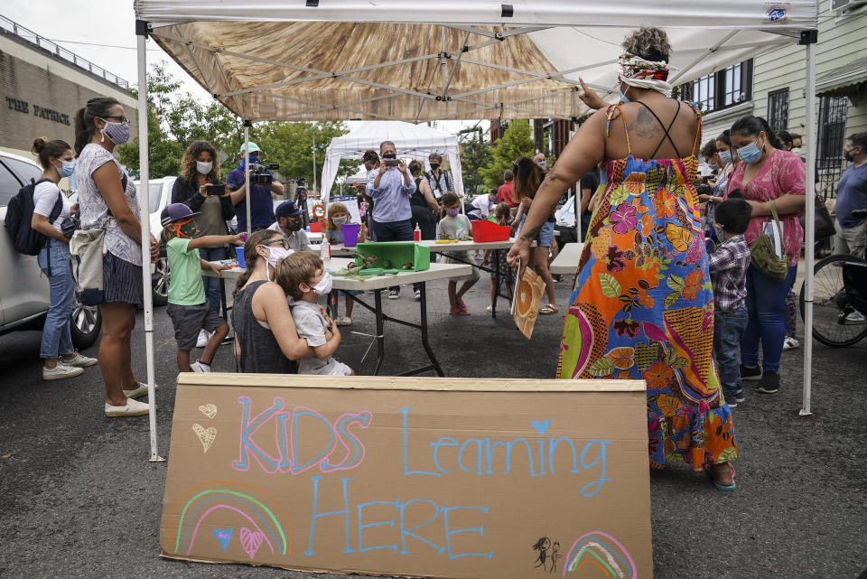 Teachers and students participate in an outdoor learning demonstration to display methods schools can use to continue on-site education during the coronavirus pandemic, Wednesday, Sept. 2, 2020, at P.S. 15 in the Brooklyn borough of New York. (AP Photo/John Minchillo)