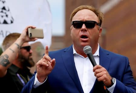 FILE PHOTO: Alex Jones from Infowars.com speaks during a rally in support of Republican presidential candidate Donald Trump near the Republican National Convention in Cleveland, Ohio, U.S., July 18, 2016. REUTERS/Lucas Jackson/File Photo