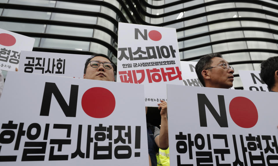 In this Aug. 7, 2019, photo, South Korean protesters hold signs during a rally demanding the abolition of the General Security of Military Information Agreement, or GSOMIA, an intelligence-sharing agreement between South Korea and Japan in front of the Japanese embassy in Seoul, South Korea. South Korea has threatened to end the military intelligence sharing agreement with Japan as their tensions escalate over export controls. The agreement, known as GSOMIA, is a symbol of the countries’ trilateral security cooperation with their ally United States in the region. The letters read "Abolition of the General Security of Military Information Agreement between South Korea and Japan." (AP Photo/Lee Jin-man)