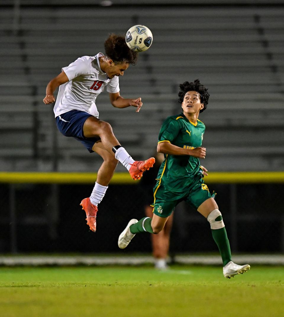 Centennial's Adrian Hammond (19) goes for a header in a District 10-7A high school boys soccer final against Jupiter, Wednesday, Jan. 31, 2024, at the South County Regional Spirts Complex in Port St. Lucie.