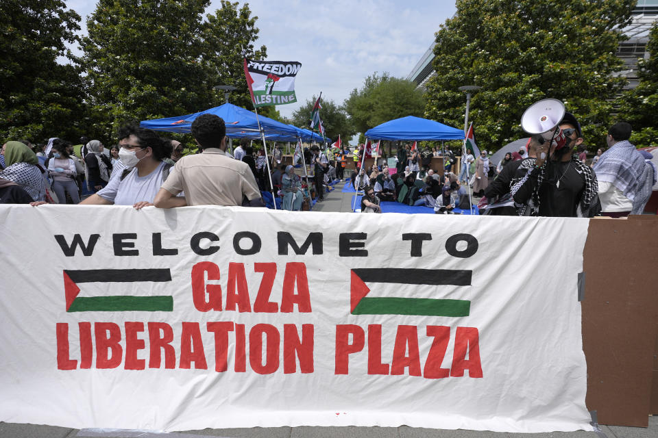 People gather to protest against the Israel-Hamas war at a plaza at the University of Texas at Dallas, Wednesday, May 1, 2024, in Richardson, Texas. (AP Photo/LM Otero)