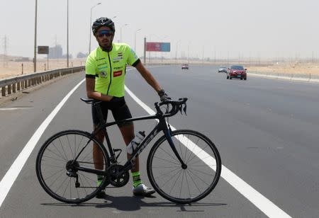 Egyptian cyclist Helmy El Saeed, 27, poses during training on the highway of El Ain El Sokhna, east of Cairo, Egypt July 19, 2017. El Saeed has become a Guinness record holder after partaking in the fastest ever Europe bicycle cross. Picture taken July 19, 2017. REUTERS/Amr Abdallah Dalsh