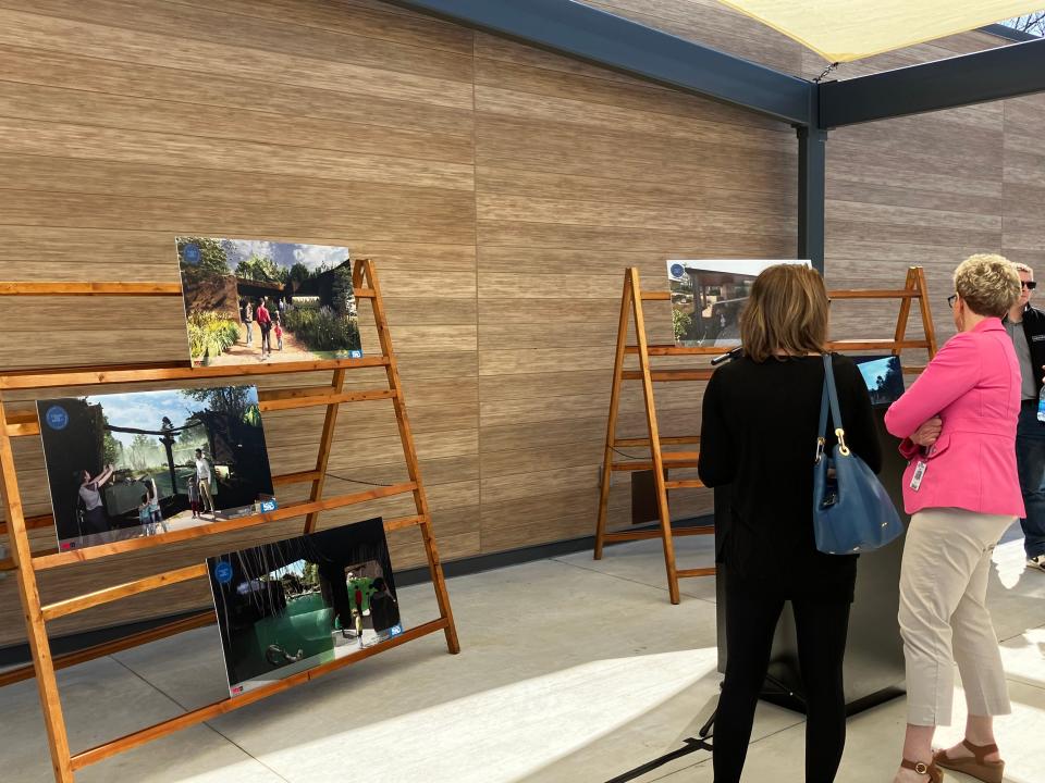 Guests view renderings of the Blank Park Zoo plan after a donor recognition ceremony Monday.