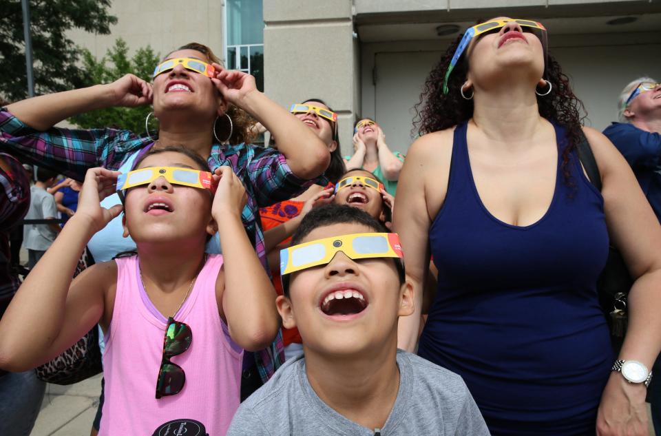 People watch the August 2017 solar eclipse at the Milwaukee Public Museum.