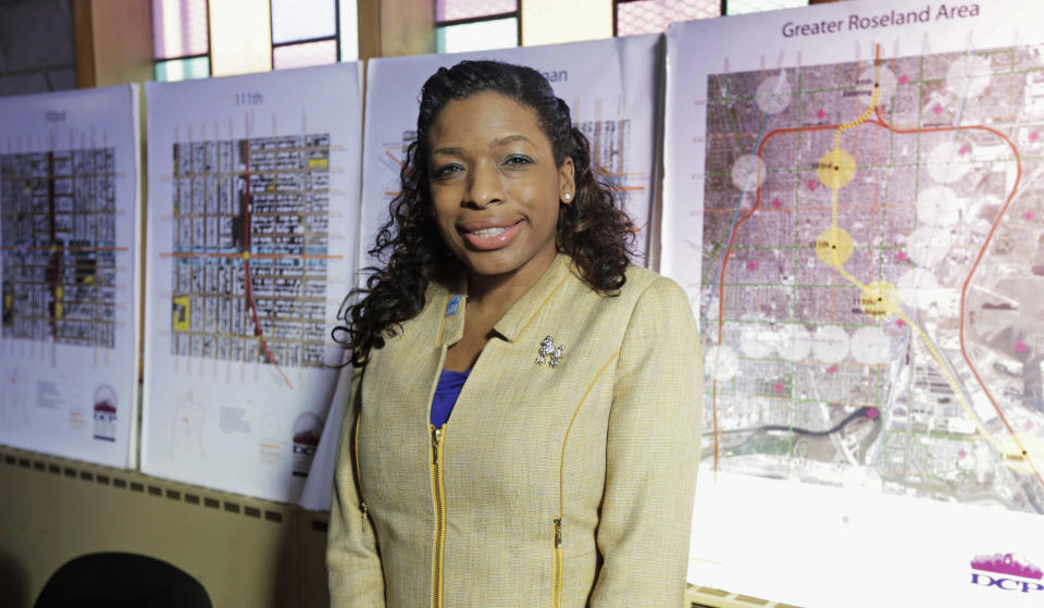 This Friday, Feb. 7, 2014 photo shows Tiffany Hightower, executive director of the not-for-profit Developing Communities Project, Inc. in her office in the south side neighborhood of Roseland in Chicago. Hightower is part of a group trying to bring a Barack Obama presidential library to Chicago State University. She believes the library would transform the area and give young people a link to the world beyond their violence-plagued streets. (AP Photo/M. Spencer Green)