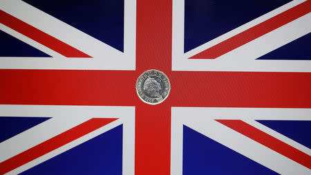 A one pound coin lies on a Union Flag in Loughborough, Britain May 3, 2017. REUTERS/Darren Staples