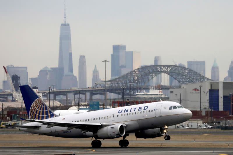 FILE PHOTO: A United Airlines passenger jet takes off with New York City as a backdrop