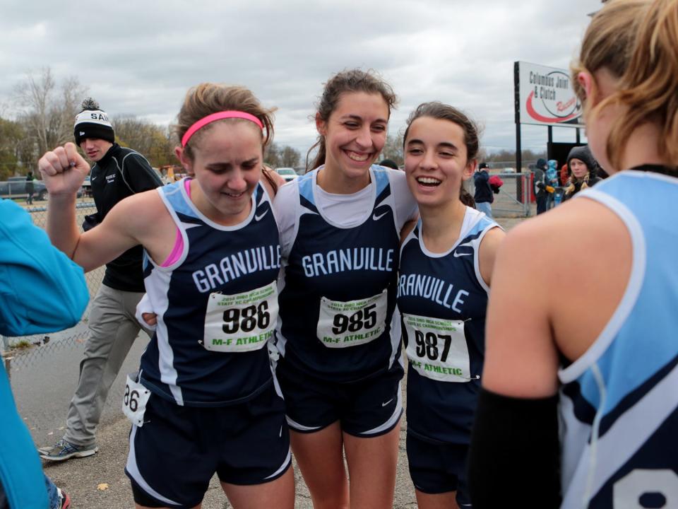 Cassidy Carey, Alyssa Atkinson and Micaela DeGenero celebrate the Division II state cross country championship in 2014. The Blue Aces were honored last Saturday as a part of DeGenero's induction into the Granville Athletic Hall of Fame.